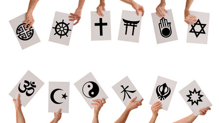 Collection of hands holding signs with sacred symbols of various world religions isolated on white background.の写真素材