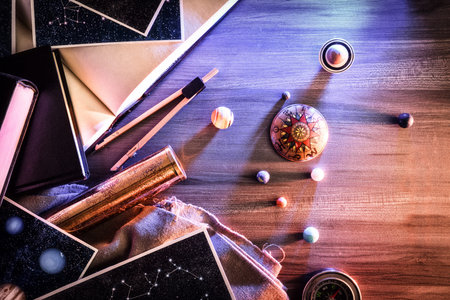 Concept of exploring planets, stars and constellations with table with images of stars and...