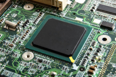A detailed close-up of a processor mounted on a printed circuit board, surrounded by soldered...