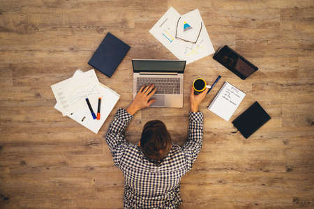 men working on laptop - creative home work space - work from home -の写真素材