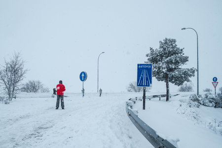 People walking on highway recovered by snow in Madrid suburbs due to Filomena stormの写真素材