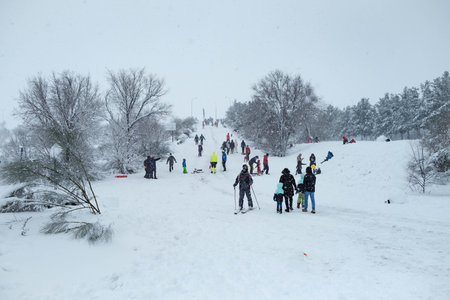 People walking under snow storm near highway entrance in Madrid suburbs during Filomena stormの写真素材
