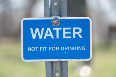 A blue warning sign with the text WATER, NOT FOR Drinkingの写真素材