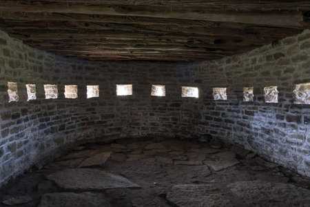 Interior of a medieval castle with stone walls and arched windows