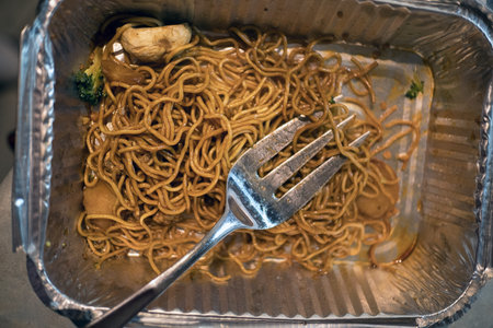 Close up of a fried noodle in a stainless steel box.