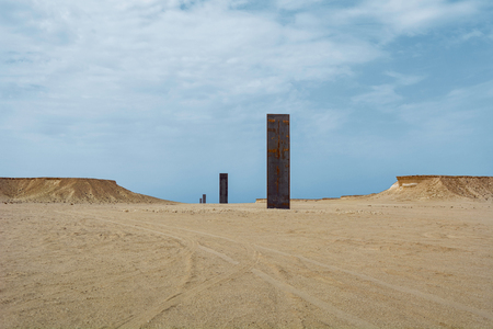 EAST-WEST WEST-EAST, QATAR - MARCH 6: East-West West-East sculpture by artist Richard Serra on March 6.2015. near village of Zekreet, Qatar.のeditorial素材