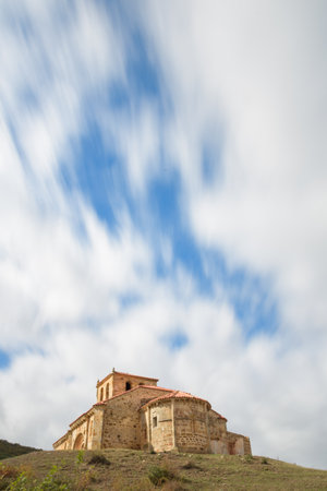 San Clemente church in Huidobro, a Romanesque gem with dynamic clouds and historic architecture.の写真素材