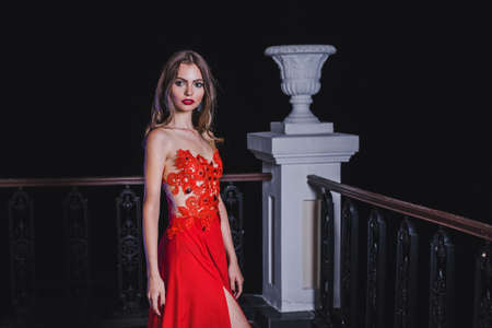 Beautiful girl in red dress with long hairの写真素材