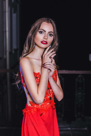 Beautiful girl in red dress with long hairの写真素材