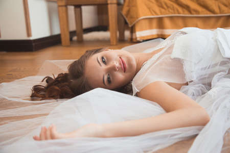 Beautiful sexy girl in boudoir white dressの写真素材