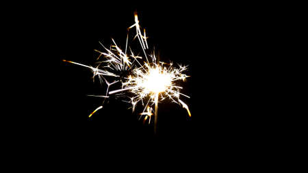 Bengal fire on black background with sparksの写真素材