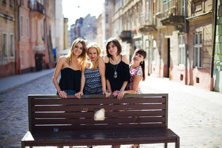 four beautiful girls posing in front of in the city.のeditorial素材