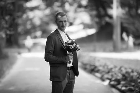Elegant bride and groom posing together outdoors on a wedding dayの写真素材