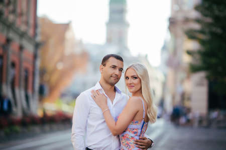 walking down the street together. Happy young man and smiling woman walking through the streets of Old Town,の写真素材