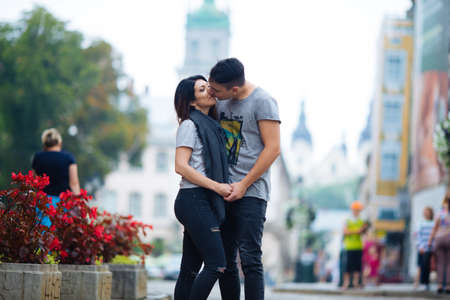 A couple in love slowly walks the streets of the city on a cool autumn morning.の写真素材