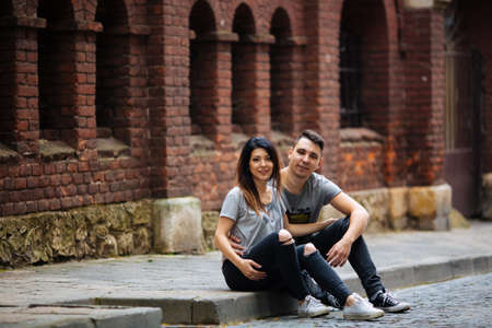 couple posing on the streets of a European city in summer weather.の写真素材