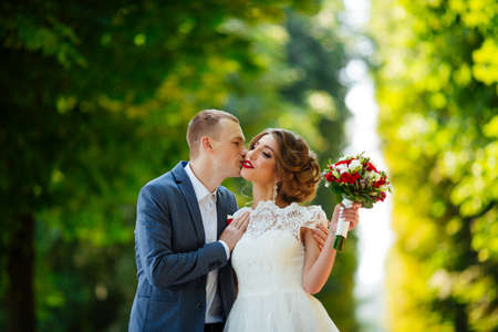 Wedding. Young couple, recently married, holding handsの写真素材