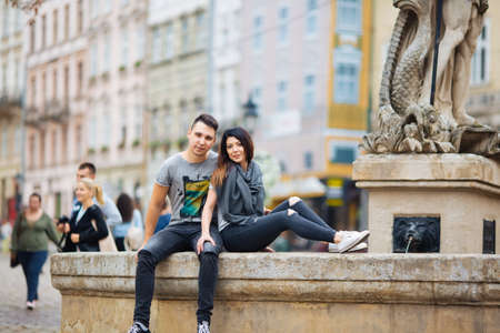 couple posing on the streets of a European city in summer weather.の写真素材