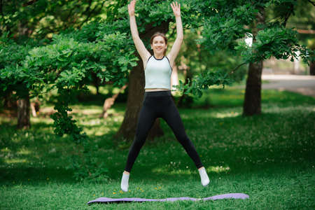 girl goes in for sports in the park of europeの写真素材