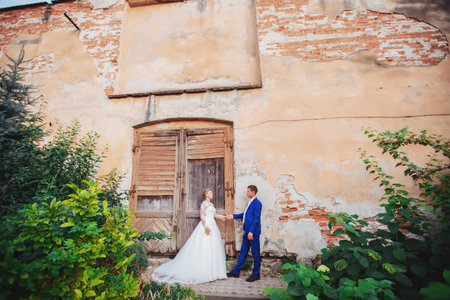 bride and groom walk around the old town.の写真素材