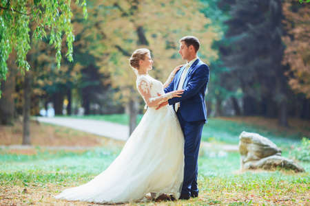 Bride and groom in the park kissing. wedding in nature green forest kissingの写真素材
