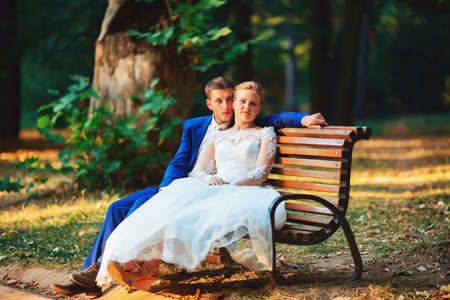 Bride and groom in the park kissing. wedding in nature green forest kissingの写真素材