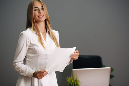 sitting at his desk in the office. Happy business woman sitting in the office