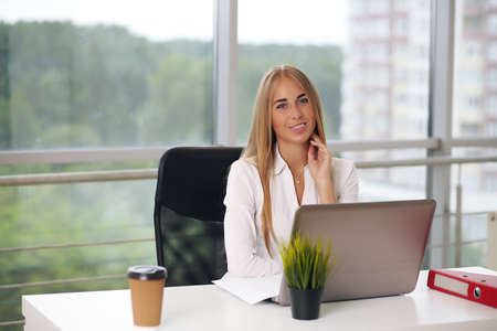 Portrait of young female designer in officeの写真素材