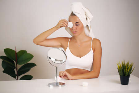 beautiful woman applying cosmetic cream, beauty and healthの写真素材