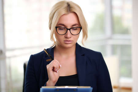 Young businesswoman in the office. Beautiful businesswoman working on her laptopの写真素材