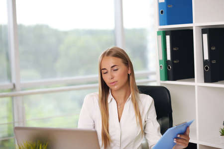 Focused woman working at her computer. Background for office startupの写真素材