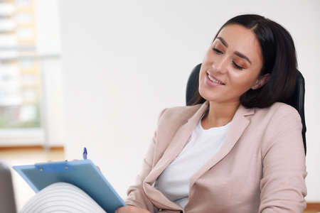 Beautiful business woman on the background of the modern officeの写真素材