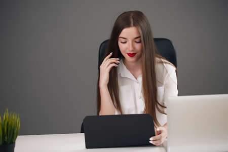The girl holds a folder. She is in a shirt. woman looking at cameraの写真素材
