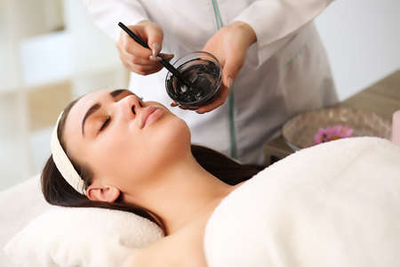 young beautiful woman with facial mask, spa treatmentの写真素材