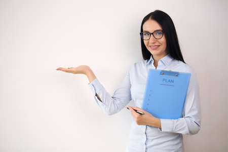 Smiling businesswoman showing open hand palm with copy space forの写真素材