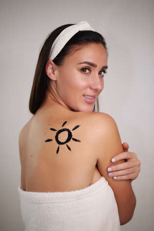 on the back of the sun, a beautiful brunette girl in a towelの写真素材