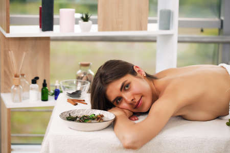 young beautiful business woman finds peace and quiet in a wellness center receiving spa treatments from professionalsの写真素材