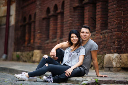 A couple in love slowly walks the streets of the city on a cool autumn morning.の写真素材