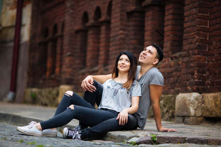 A couple in love slowly walks the streets of the city on a cool autumn morning.の写真素材