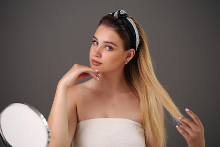 Beauty close-up portrait of beautiful, fresh and healthy girl over grey background.の写真素材