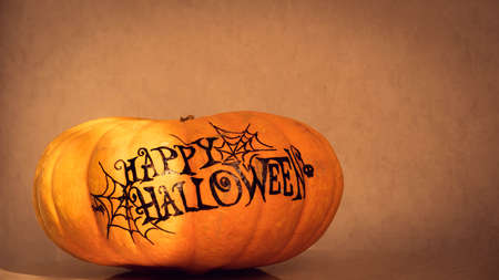 orange pumpkin with the inscription happy Halloween with a layout for your text, a celebration concept and an invitation to Halloweenの写真素材