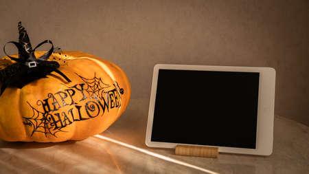 orange pumpkin with the inscription happy Halloween with a layout for your text, a celebration concept and an invitation to Halloweenの写真素材