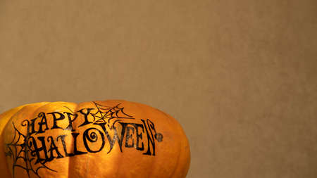 orange pumpkin with the inscription happy Halloween with a layout for your text, a celebration concept and an invitation to Halloweenの写真素材