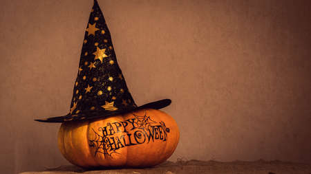 orange pumpkin with the inscription happy Halloween with a layout for your text, a celebration concept and an invitation to Halloweenの写真素材