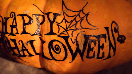 orange pumpkin with the inscription happy Halloween with a layout for your text, a celebration concept and an invitation to Halloweenの写真素材