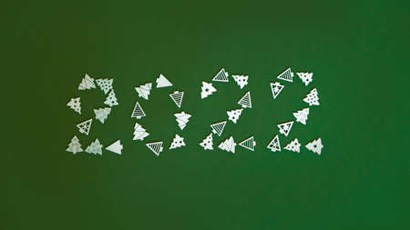 Christmas figures 2022 on a green background of figures of Christmas trees and snowflakes ,the concept of Christmas and new year with a place for textの写真素材