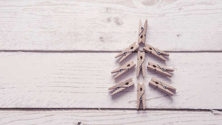 creative Christmas tree made of small figures of Christmas trees on a green background,a Christmas concept with a place for textの写真素材