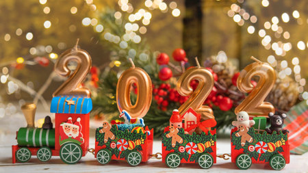 the figures of the new year 2022 on the Christmas locomotive of Santa Claus on a white wooden background with a bokeh ,the concept of Christmasの写真素材