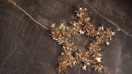 a mock-up of a Christmas star with a place for golden tinsel text , the concept of Christmas , black...