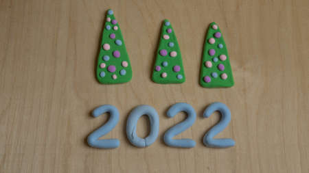 blue numbers 2022 made of plasticine and creative Christmas treesの写真素材